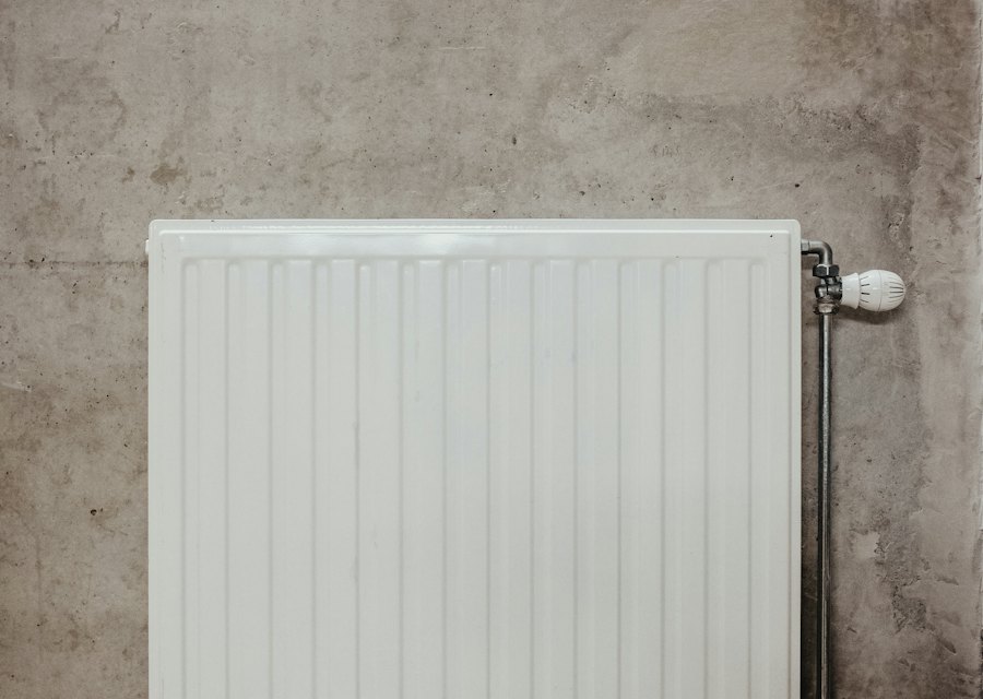White panel radiator with a thermostatic valve